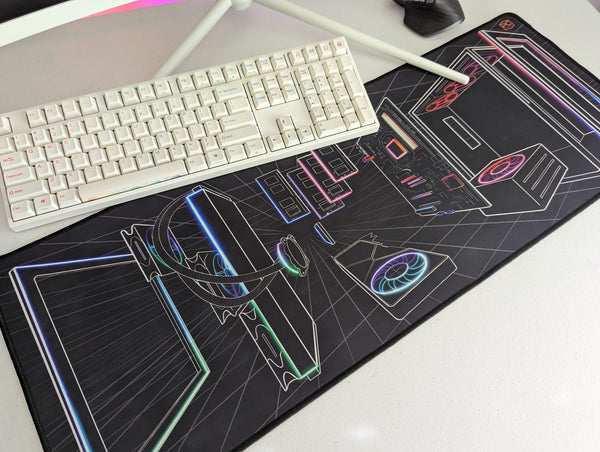 Desk mat on desk with keyboard, monitor, and mouse.